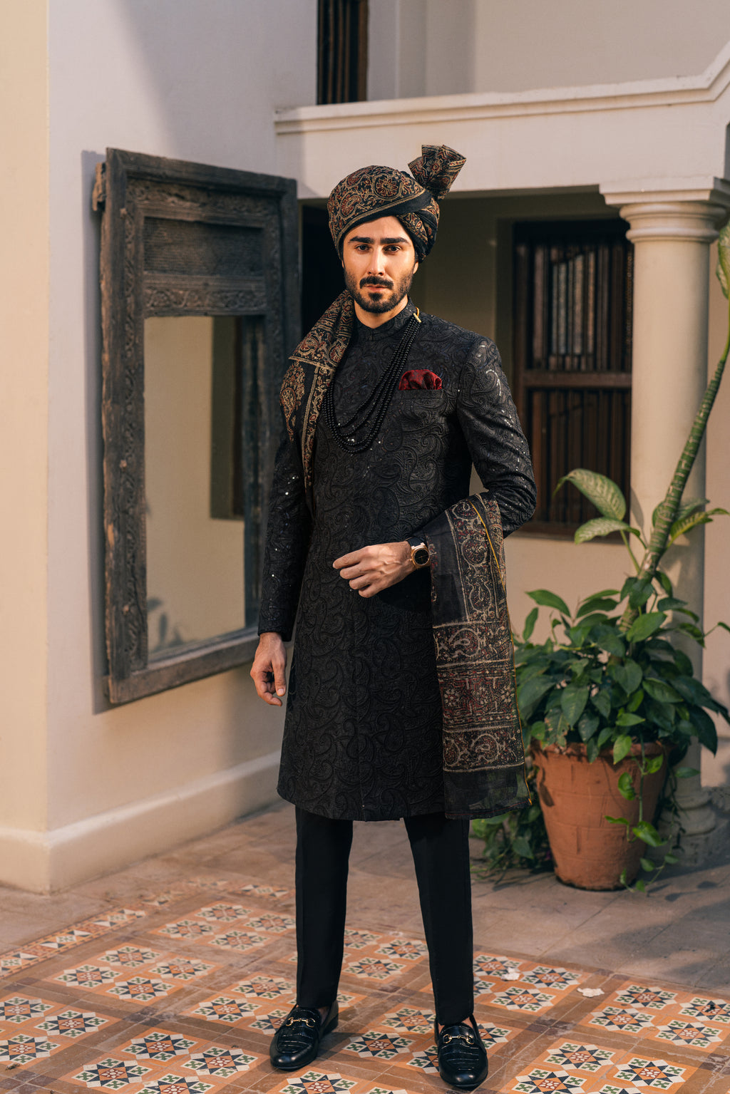 Black Sherwani adorned with self-embroidery humyaunalamgir S
